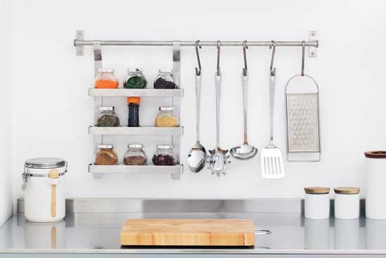
Install wall railings above kitchen counters to hang dishtowels or utensils and cut down on counter clutter.
